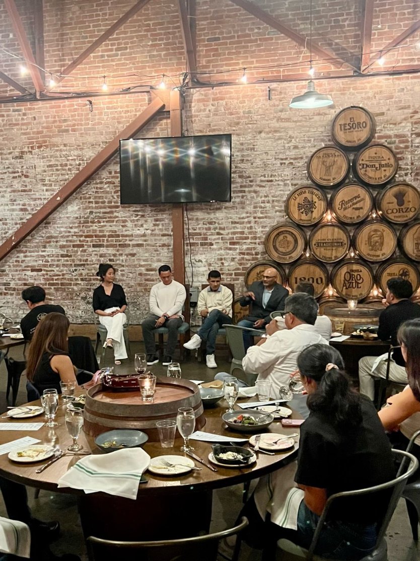 Leaders seated around tables during the panel